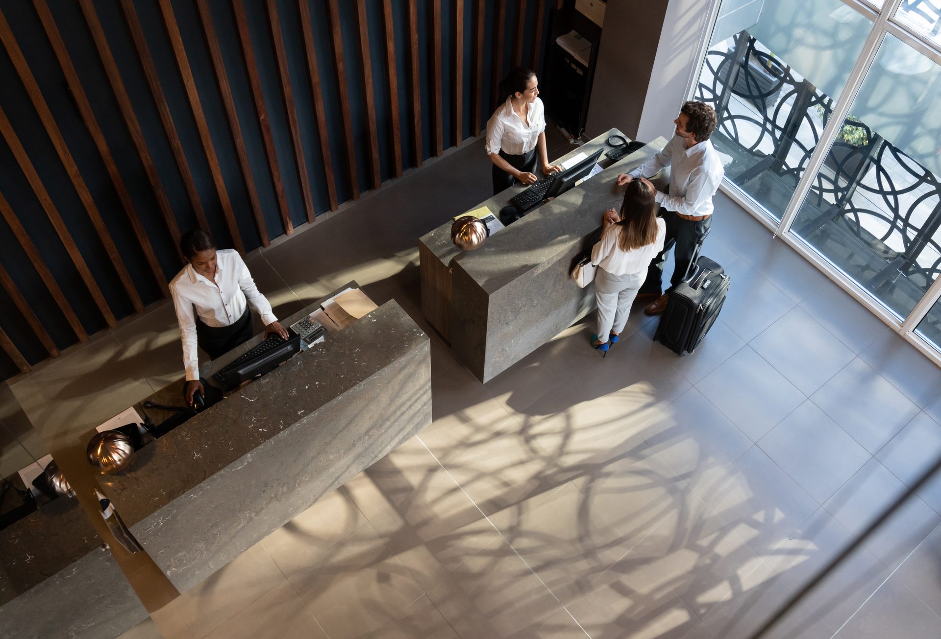 Aerial view of hotel lobby with guests at check-in