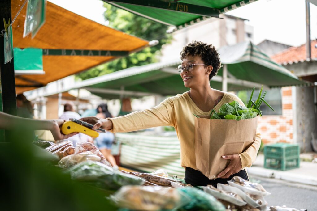 Woman shopping for vegetables at an outdoor market