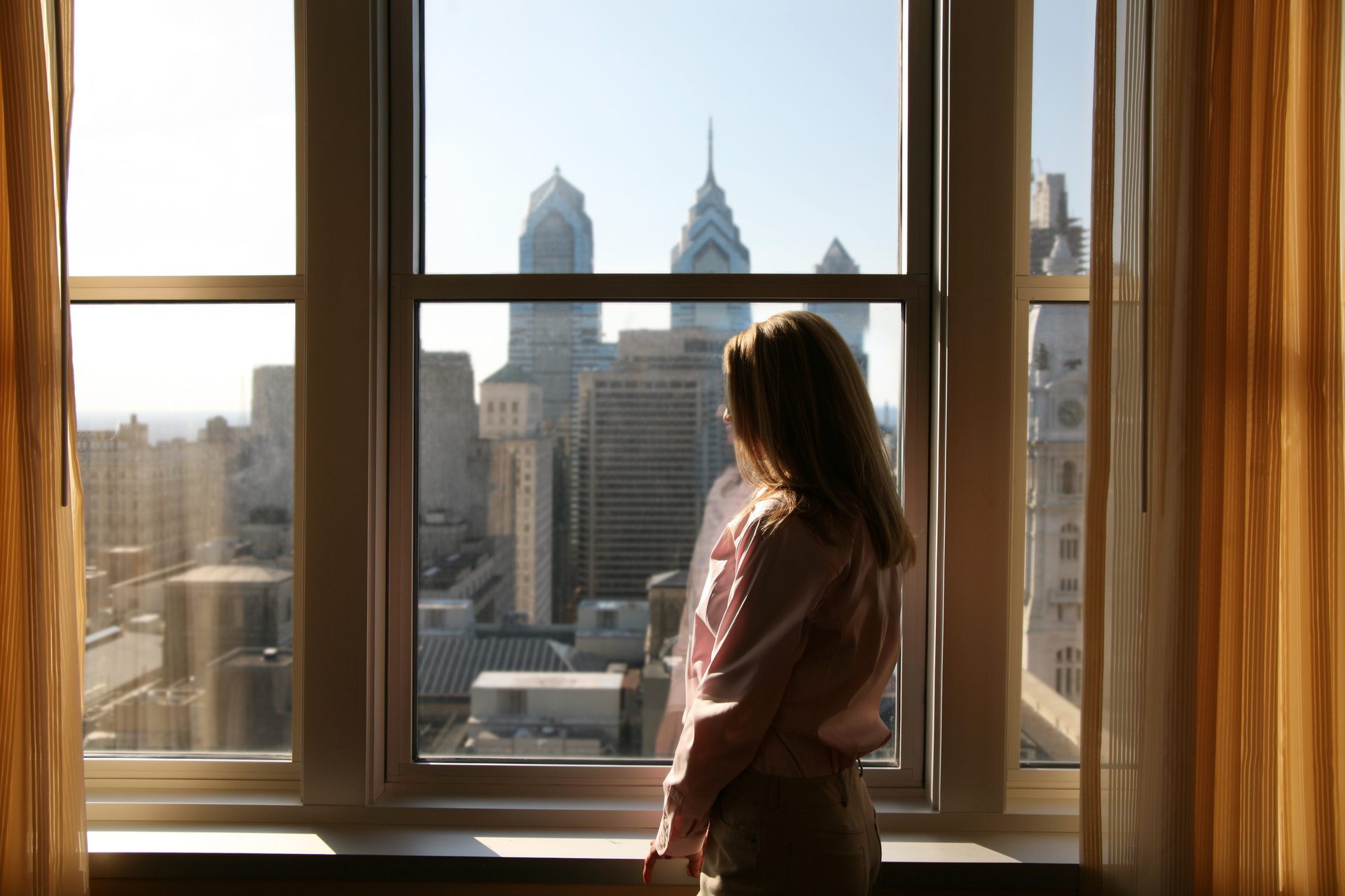 Hotel window view of a city skyline