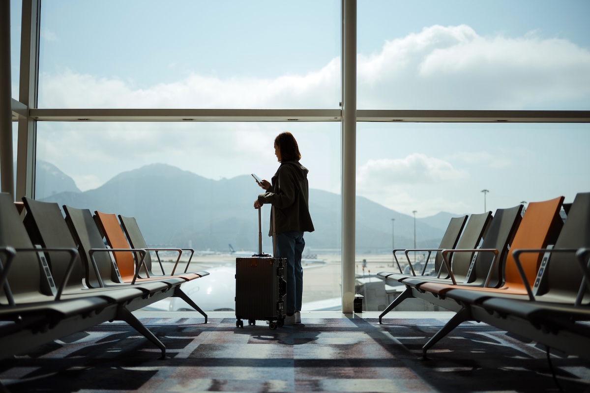 Airport gate with a woman on her cell phone